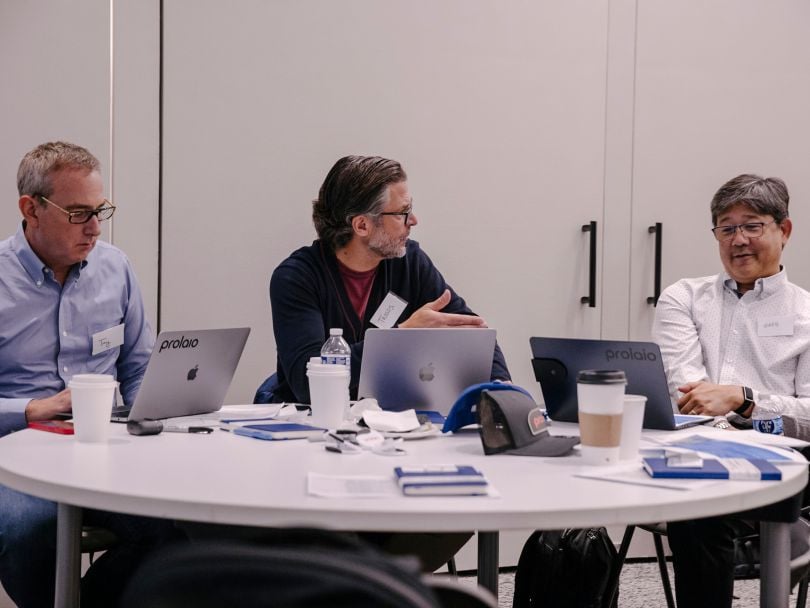 Jay Edelberg, Co-Founder (left) and Greg Kurio, Chief Medical Officer (right) talk with Prolaio CEO and Co-Founder Tassos Gianakakos (center) at a table in the company’s office